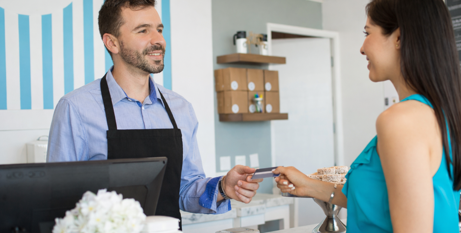 Eine Frau bezahlt an einer Kasse mit Karte